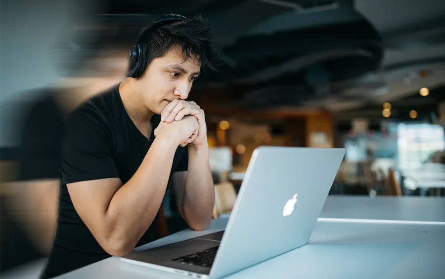 Image of man looking at laptop